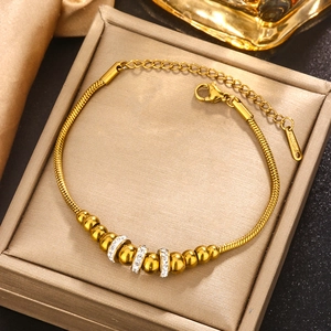 Elegant gold plated stainless steel beaded bracelet with sparkling crystal accents in a box