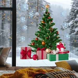 Detail of Christmas tree with ornaments, gift boxes, and snowflake window stickers