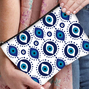 Handheld evil eye print cosmetic bag with blue pattern and black zipper closure