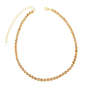 Detail of gold-plated tennis necklace with round red zircon stones and lobster clasp