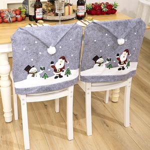 Gray Christmas chair covers featuring festive snowman and tree prints in a home setting
