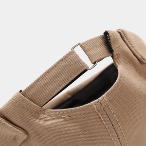 Detailed macro view of khaki cotton twill fabric and adjustable metal buckle on hat