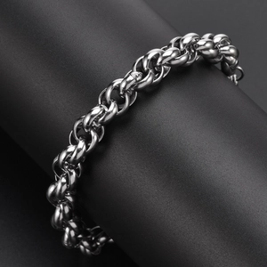 Polished silver stainless steel chain link bracelet displayed on black jewelry stand