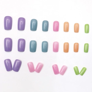 Colorful aurora square press-on nails in purple, blue, pink, and green on white background