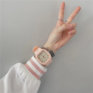 Girl's pink silicone square quartz watch styled with a metal chain bracelet on wrist