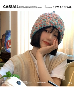 Detail of multi-color thick knit bucket hat showing pink blue and orange yarn texture