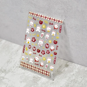 Macro detail of 5D embossed nail stickers with white rabbits and lucky red envelopes