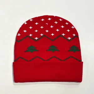 Close-up of red Christmas knit hat with snowflake and green tree patterns for winter