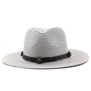 Close-up of grey straw hat with dark brown leather band and metallic ornaments