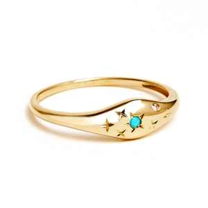 Macro detail of gold S925 silver ring with turquoise stone and starburst engravings