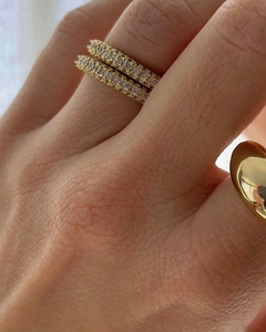 Macro shot of gold stacked rings with half-circle micro-paved zircons for a vintage look