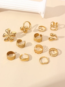 Flat lay of 12pcs gold petal and flower rings set with hollow and wavy designs