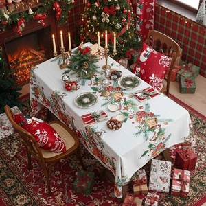 Mantel navideño con motivos de pino rojo y decoración festiva en mesa de comedor