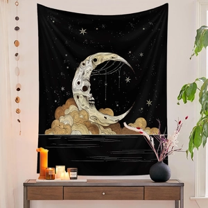 Gothic moon skull tapestry displayed over a wooden table with home decor items