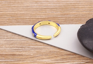 Detailed macro view of 18K gold plated ring with blue enamel and zircon inlay decoration