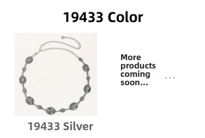 Detail of silver chain belt featuring engraved oval metal discs and lobster clasp closure
