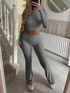 Women's grey Y2K tight long sleeve crop top and flared yoga pants set for fitness