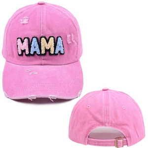 Detailed macro view of embroidered MAMA letters and distressed pink washed cotton fabric