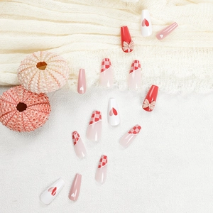 Press-on nail set featuring grapefruit red checkerboard and 3D bow heart designs