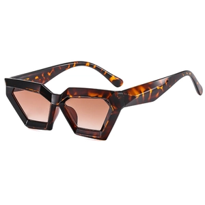 Tortoiseshell geometric cat-eye sunglasses with brown gradient lenses at a side angle