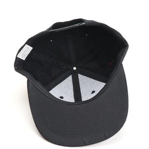 Inside view of black acrylic baseball cap showing adjustable strap and fabric label