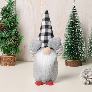 Close-up of festive Christmas gnome doll in plaid hat with playful covering eyes gesture