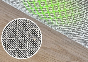 Macro detail of anti-slip cotton linen backing with green silicone grid on retro rug