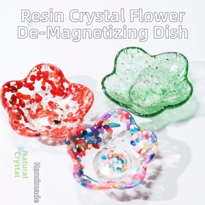 Three flower-shaped resin trays filled with natural crystal stones for cleansing and decor