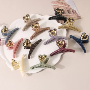 11-piece set of heart-shaped hair claw clips in various colors with gold accents