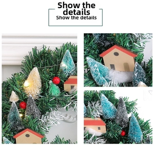 Close-up of LED Christmas wreath featuring miniature houses, berries and pine needles