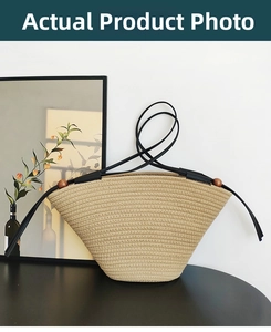 Detailed weave pattern of minimalist beige tote bag with black leather strap and wooden beads