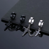 Macro detail of silver and black stainless steel cross pendant earrings with chains