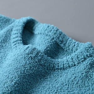 Close-up of premium lake blue chenille knit texture on a crew neck sweater