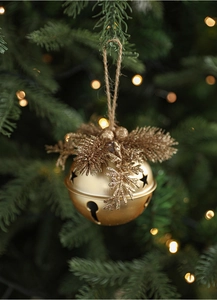 Detail of golden Christmas bell with pine needles and glitter hanging on tree branch