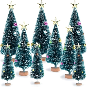 Miniature green Christmas trees with colorful ornaments and wooden bases on white background