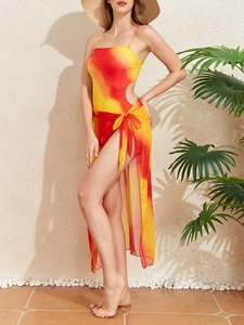 Detail of red and yellow gradient cutout swimsuit with matching sheer sarong skirt