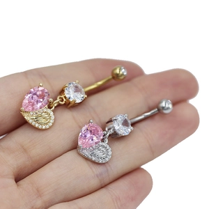 Detail of gold and silver belly rings featuring pink pear-shaped zircon and wing design