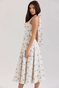 Detail of elegant backless halter dress with blue floral pattern and tie-back neck design