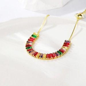 Detail of adjustable gold bracelet featuring rectangular multi-colored zircon stones