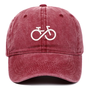Close-up of bicycle embroidery on a washed burgundy cotton baseball cap with stitch detail