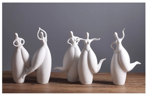Detailed view of five modern abstract white ceramic dancer sculptures for home decoration