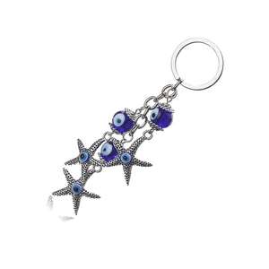 Blue Evil Eye keychain with starfish pendants and silver rings on white background
