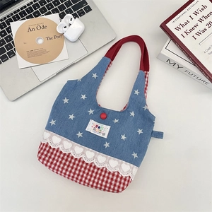 Detail of blue denim and red plaid tote bag with white lace trim and SOZAKKA logo