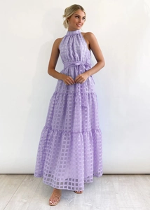 Detail of lavender tiered maxi dress featuring checkered texture and halter neckline
