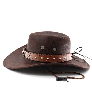 Detail of brown cowboy hat featuring metal skull ornament and silver star rivets