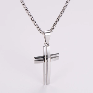 Detailed view of hollow stainless steel cross pendant on a silver ball chain necklace