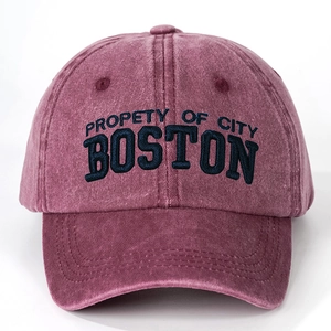 Close-up of vintage washed burgundy baseball cap with blue Boston embroidery detail
