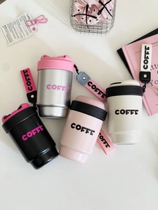 Flat lay of colorful stainless steel coffee tumblers with handles and silicone sleeves
