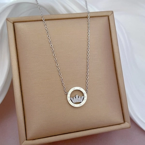 Detailed close-up of a silver titanium steel crown necklace with LUCKY engraving
