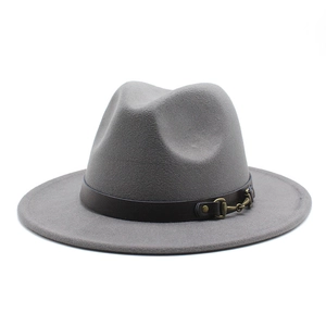 Detail of grey wool fedora hat with brown crocodile leather band and gold horsebit buckle
